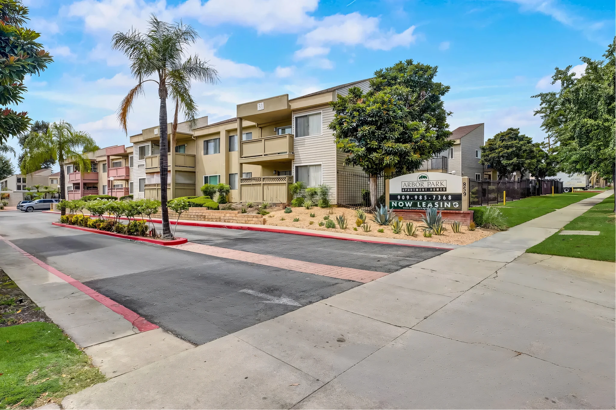 Arbor Park Apartments community entrance with leasing sign