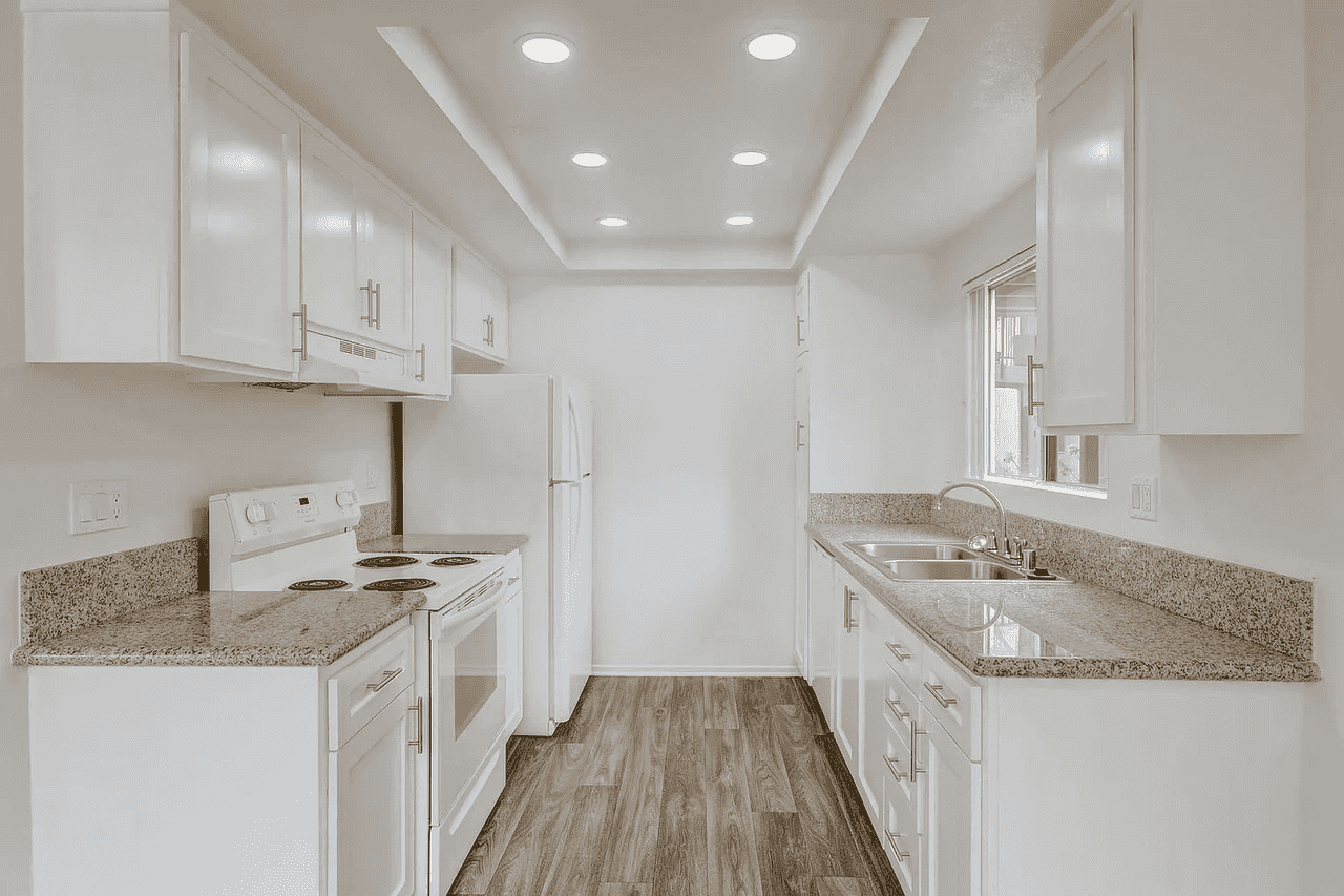 renovated galley kitchen with granite countertops