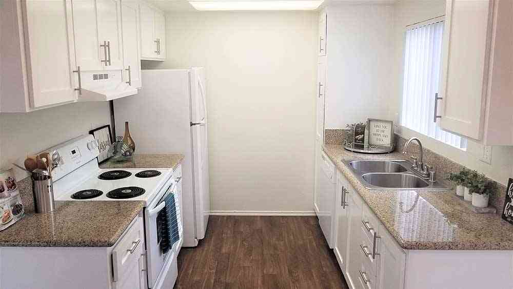 bright galley kitchen with shaker style cabinets