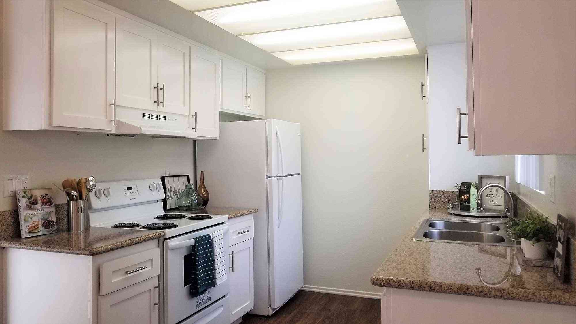 bright galley kitchen with modern lighting