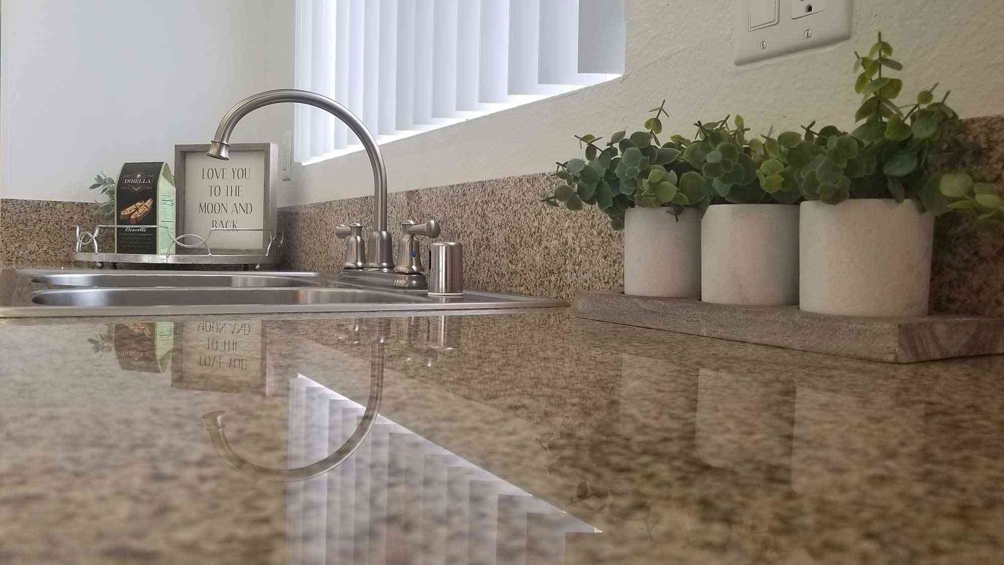 close up granite countertop and stainless steel sink