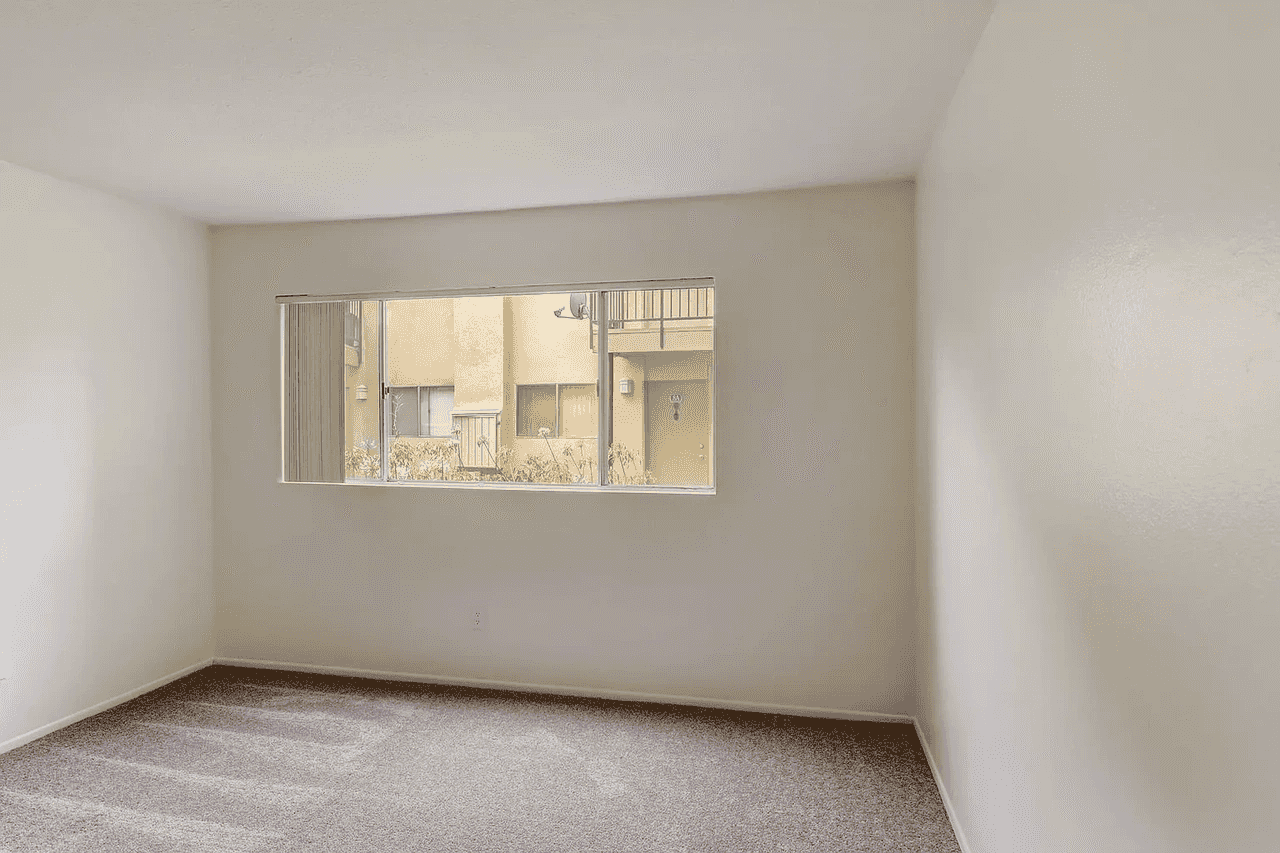 cozy bedroom with plush carpeting and window