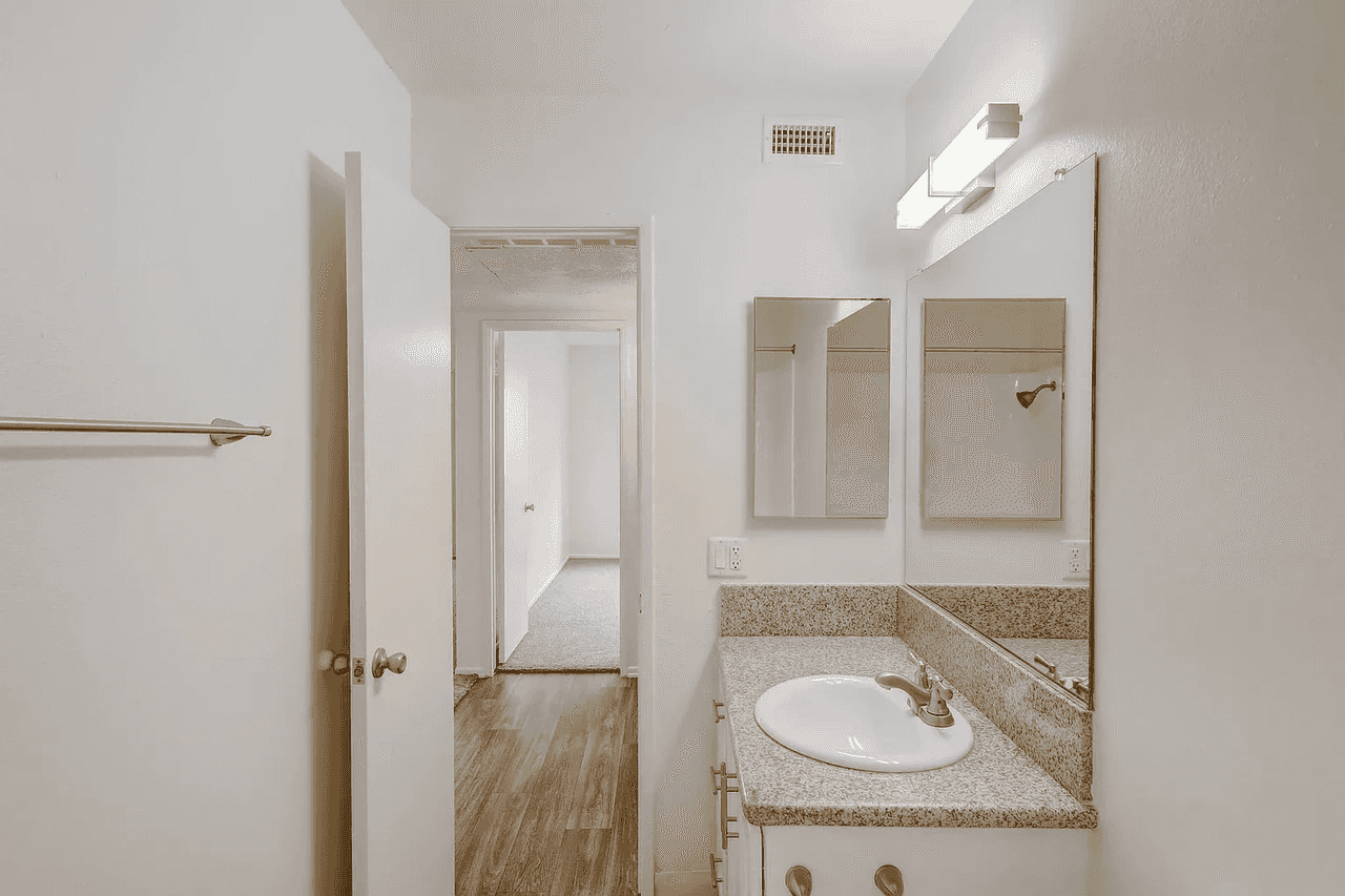 renovated bathroom with granite style countertop